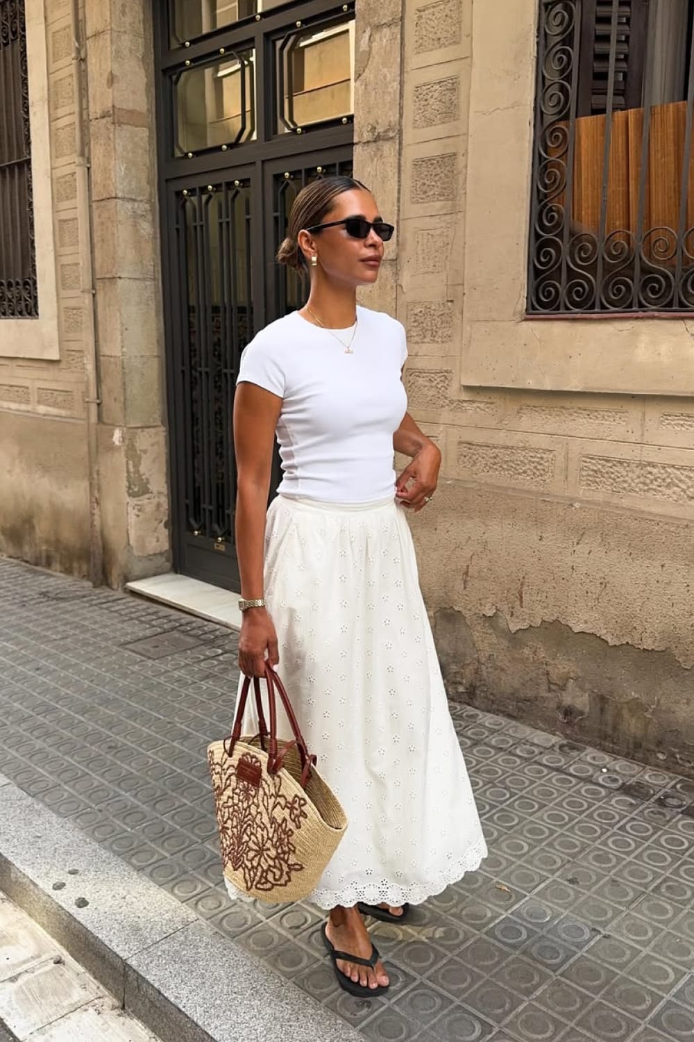 Jupe longue blanche en broderie anglaise portée en total look blanc pour l'été