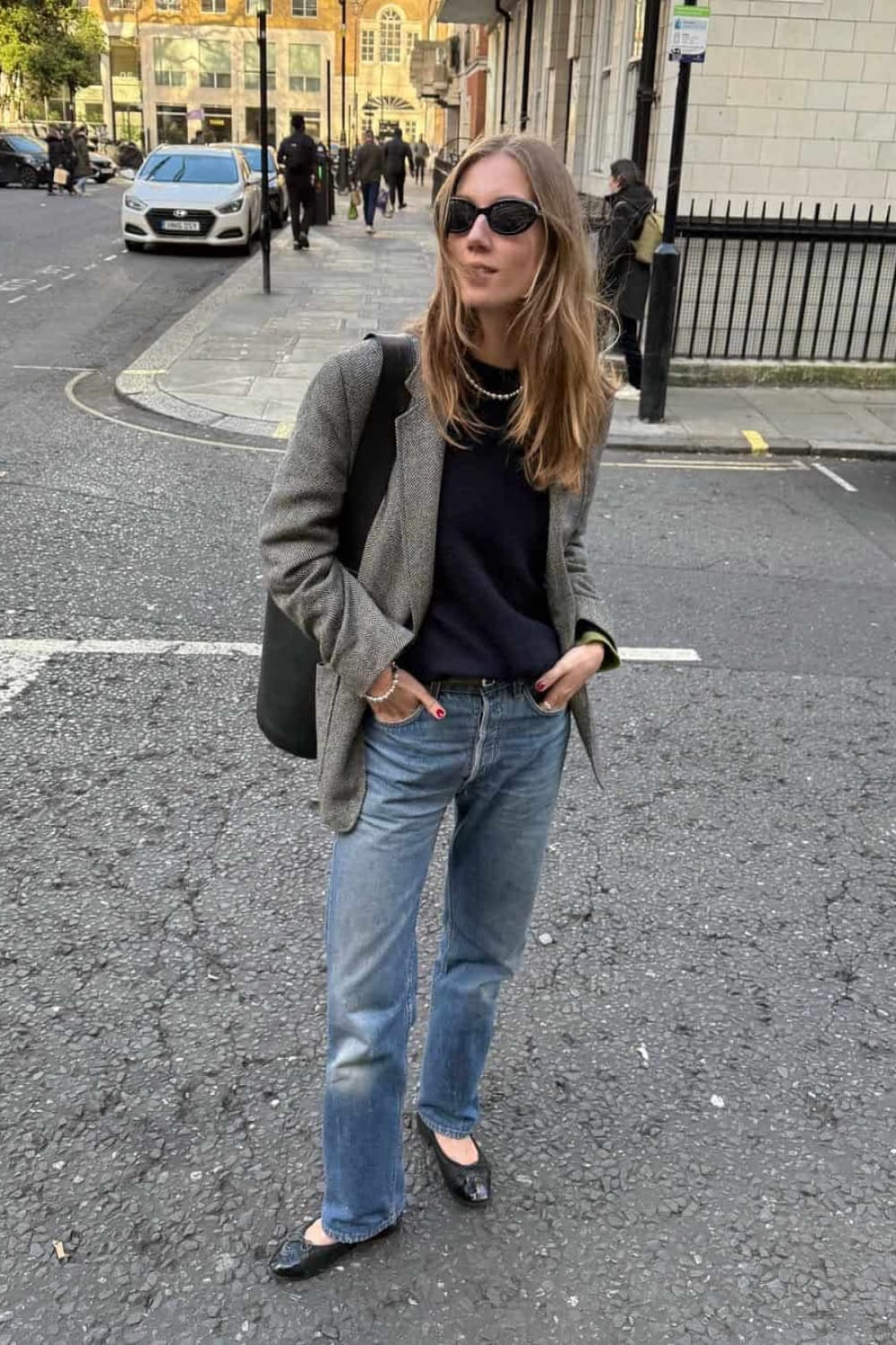 Look casual chic de rentrée avec blazer gris, pull bleu marine, jean droit délavé et ballerines noires